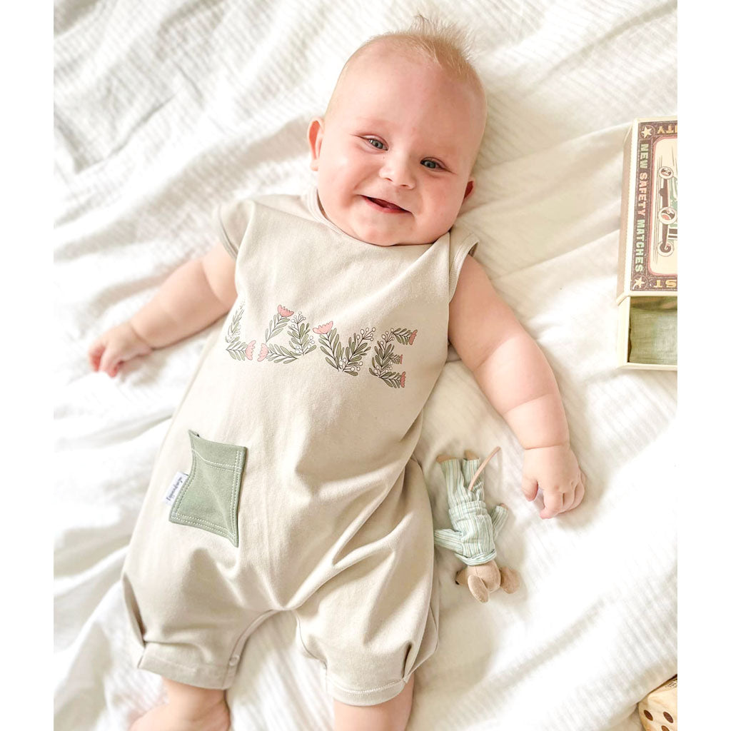 baby wearing summer playsuit